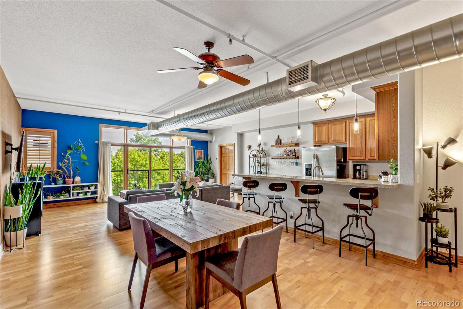 3299 Lowell Boulevard, Unit 302 Denver, CO 80211 - Photo 25 of 50 a view of a dining room with furniture and wooden floor