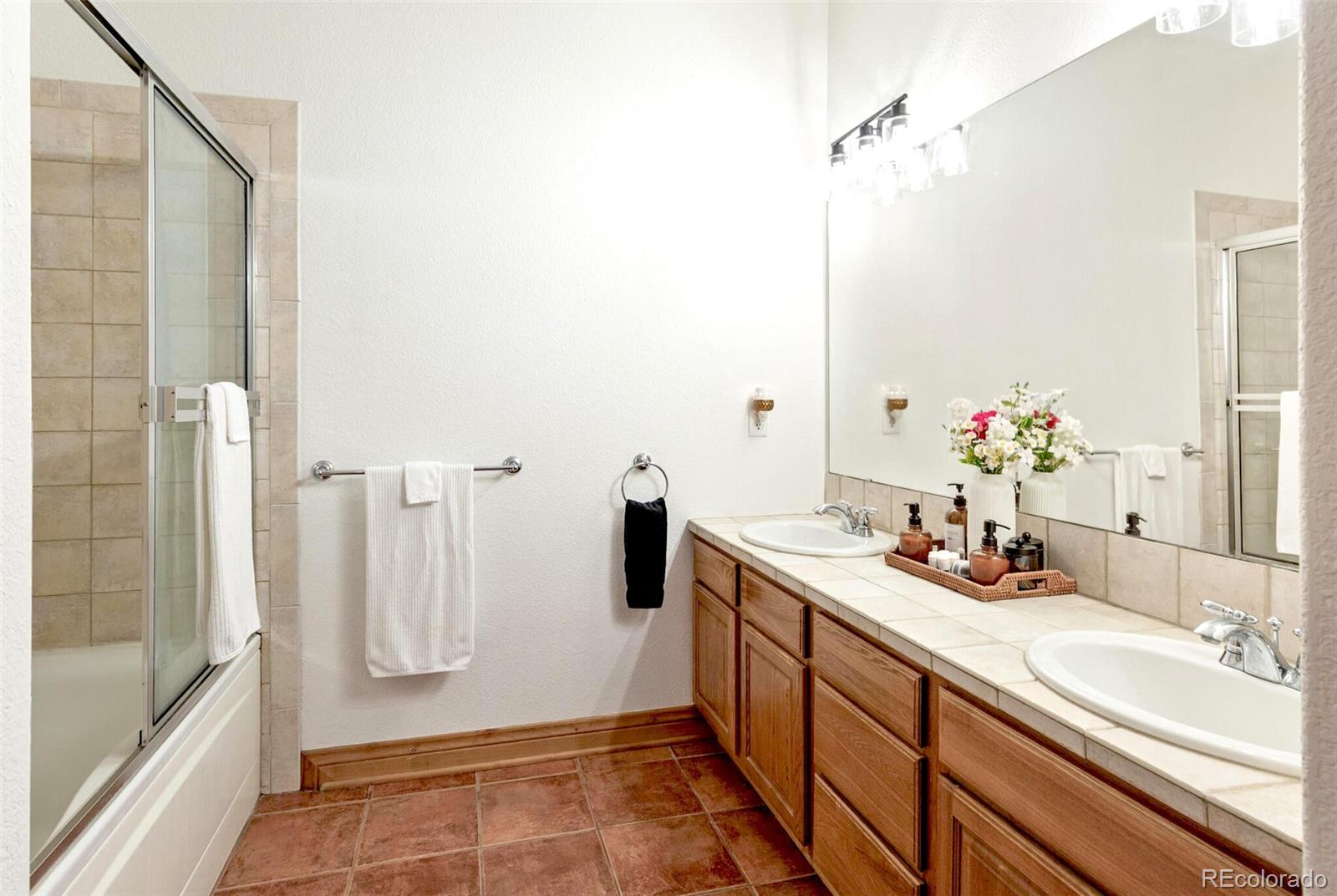 3299 Lowell Boulevard, Unit 302 Denver, CO 80211 - Photo 26 of 50 a bathroom with a sink and a mirror