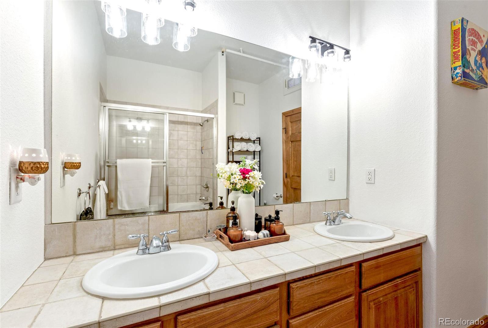 3299 Lowell Boulevard, Unit 302 Denver, CO 80211 - Photo 27 of 50 a bathroom with a sink and a mirror