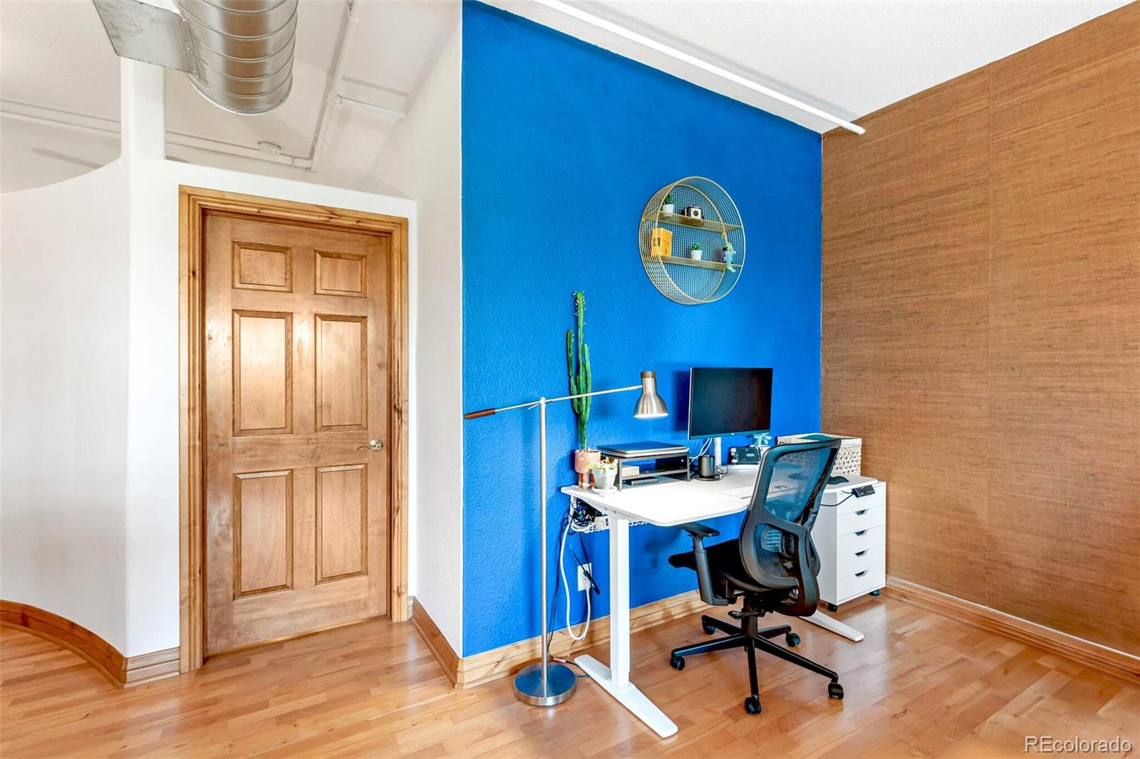 3299 Lowell Boulevard, Unit 302 Denver, CO 80211 - Photo 28 of 50 a view of a workspace with furniture and wooden floor