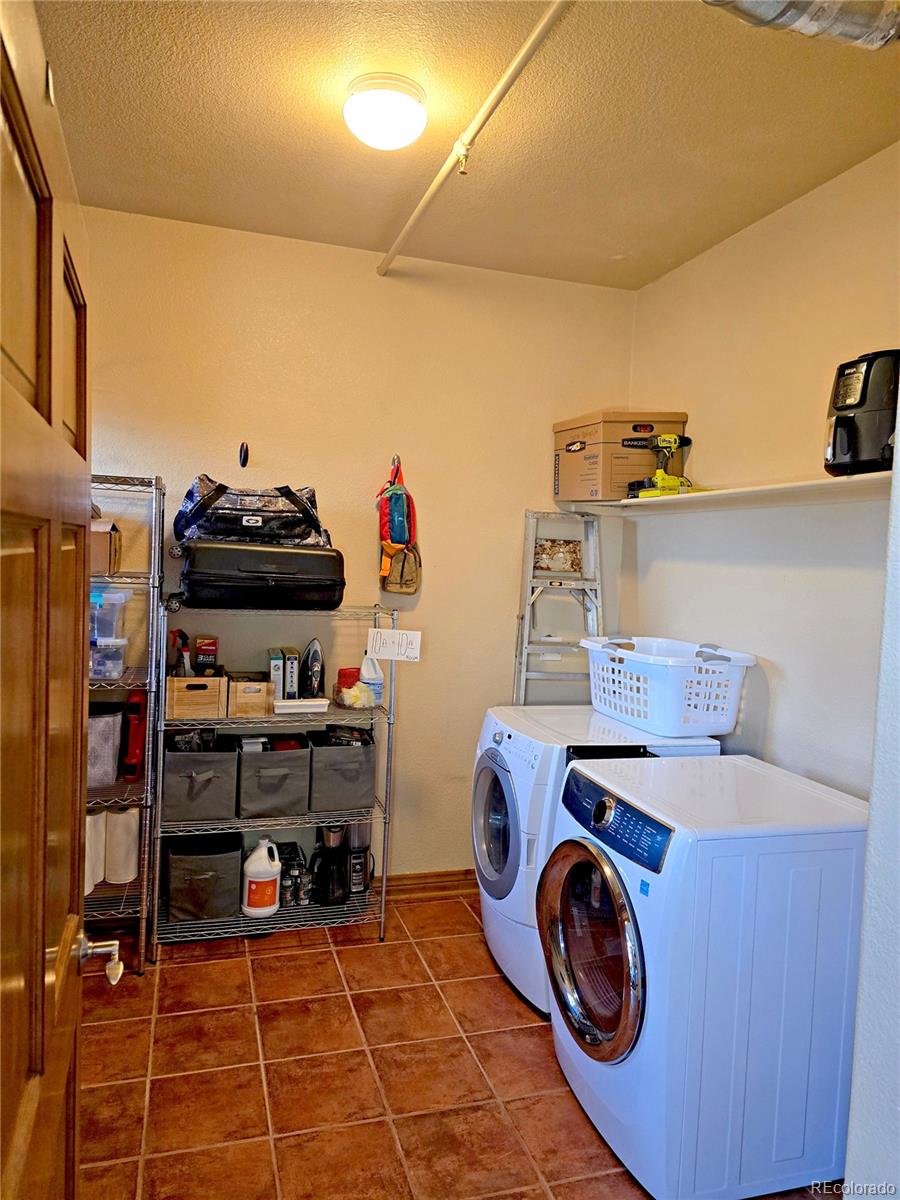 3299 Lowell Boulevard, Unit 302 Denver, CO 80211 - Photo 34 of 50 a utility room with dryer and washer