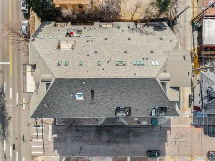 a aerial view of a white building with outdoor seating