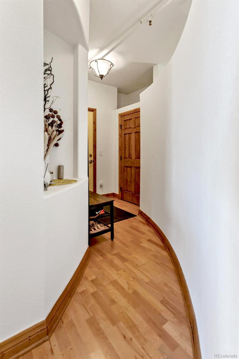 3299 Lowell Boulevard, Unit 302 Denver, CO 80211 - Photo 9 of 50 an empty room with windows and ceiling fan