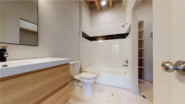 a bathroom with a toilet sink and mirror