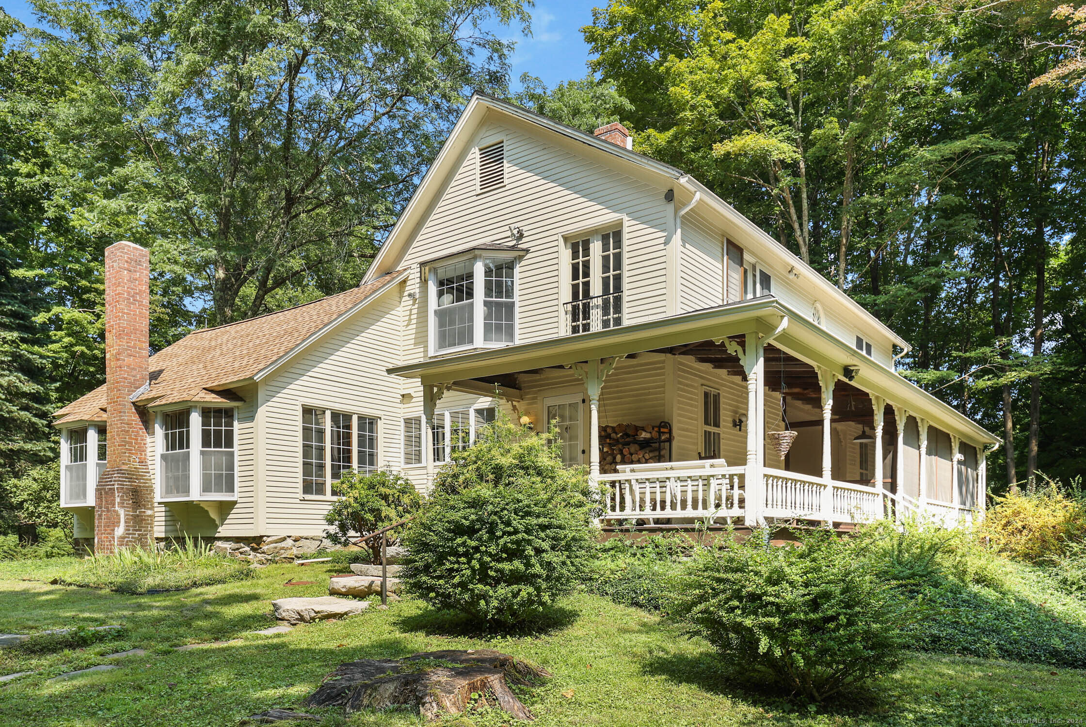 a view of a white house with a yard