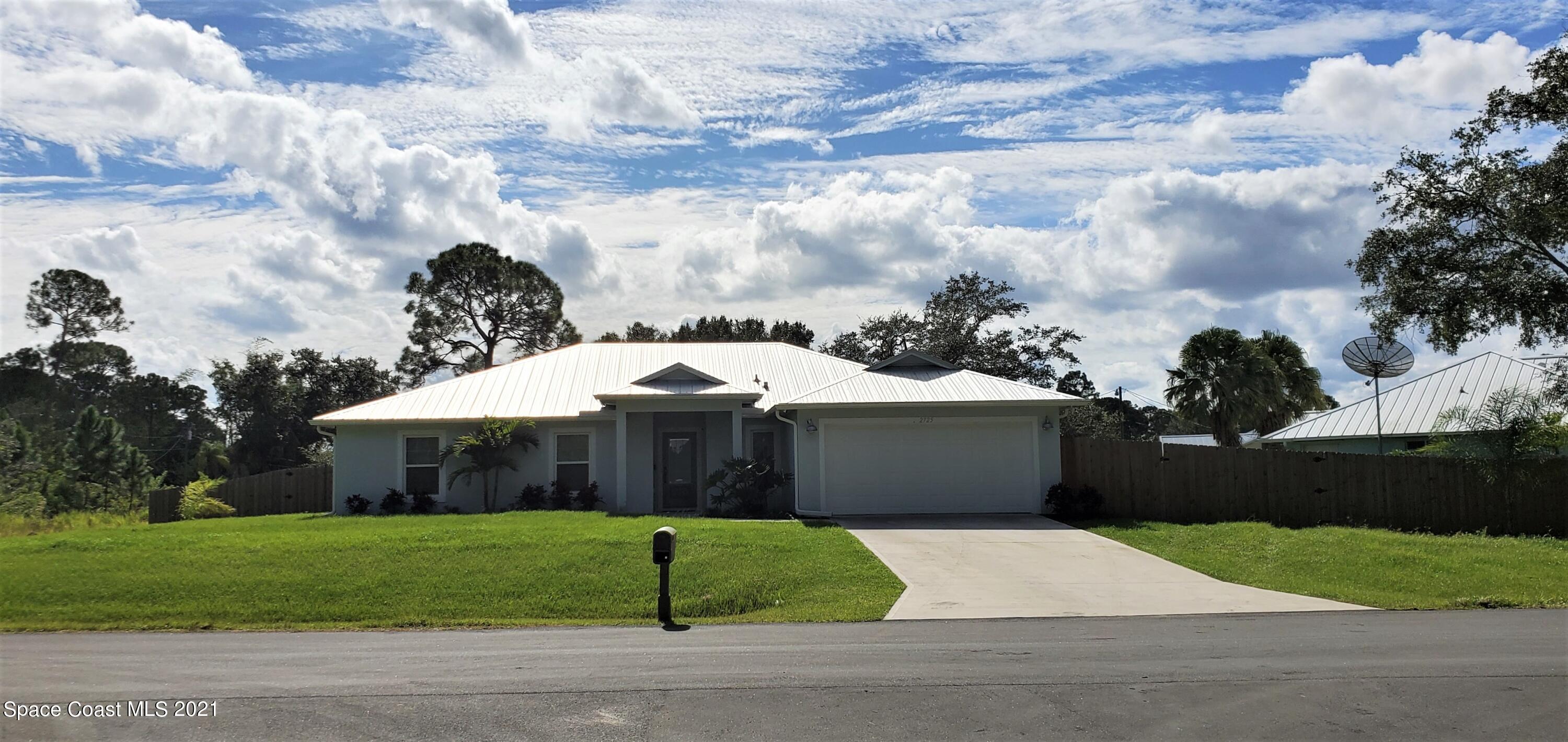 2725 Digby Road Southeast Palm Bay, FL 32909 - Photo 1 of 33 a front view of a house with a garden