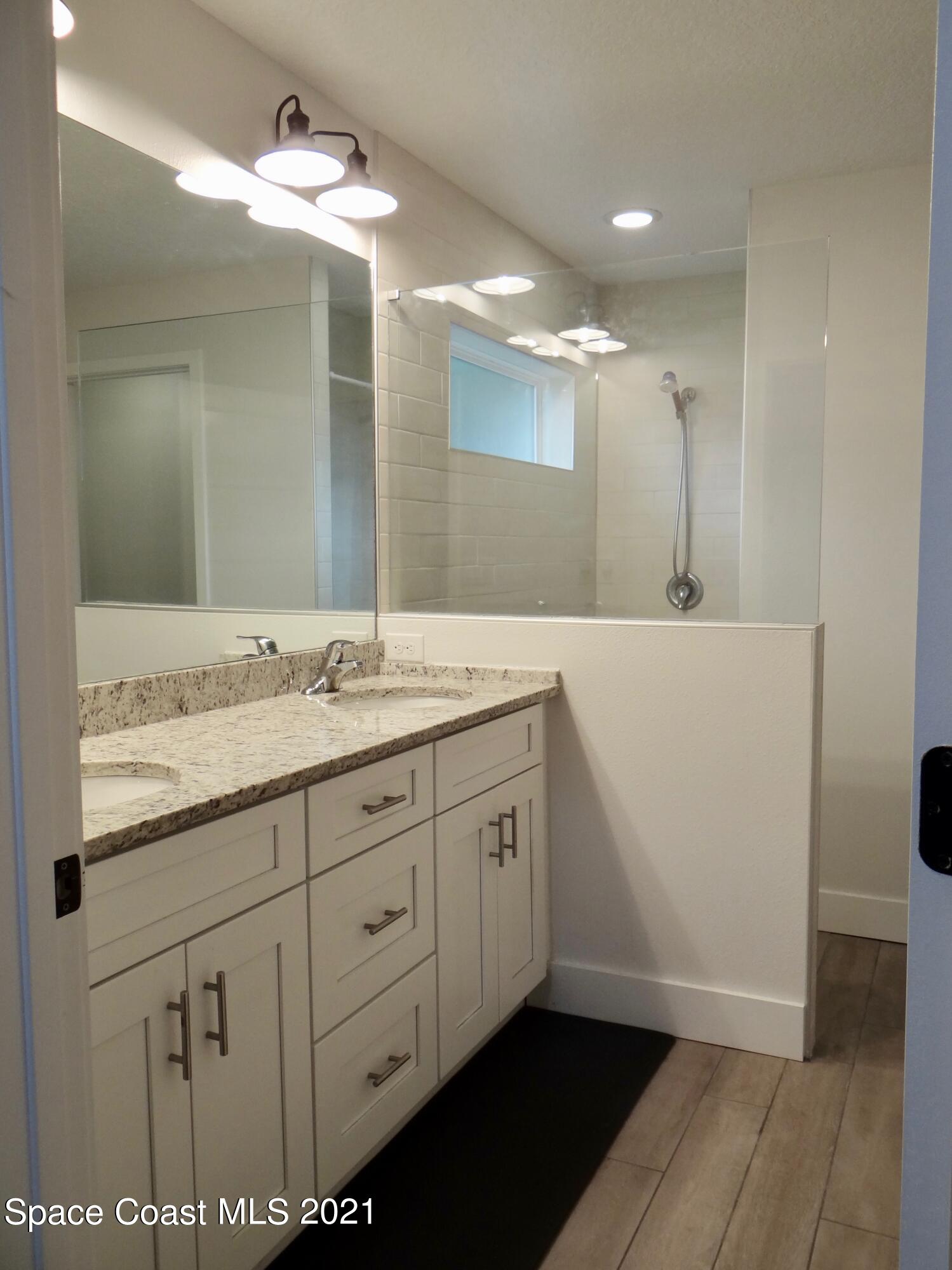 2725 Digby Road Southeast Palm Bay, FL 32909 - Photo 17 of 33 a bathroom with a granite countertop sink and a mirror