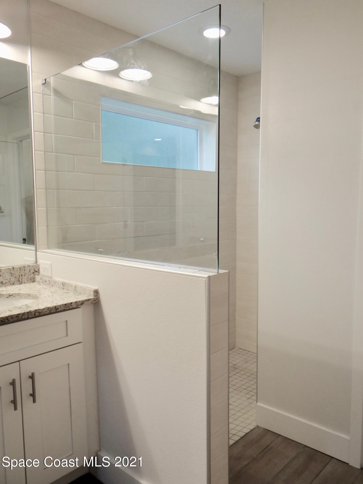 2725 Digby Road Southeast Palm Bay, FL 32909 - Photo 19 of 33 a bathroom with a granite countertop sink and a mirror