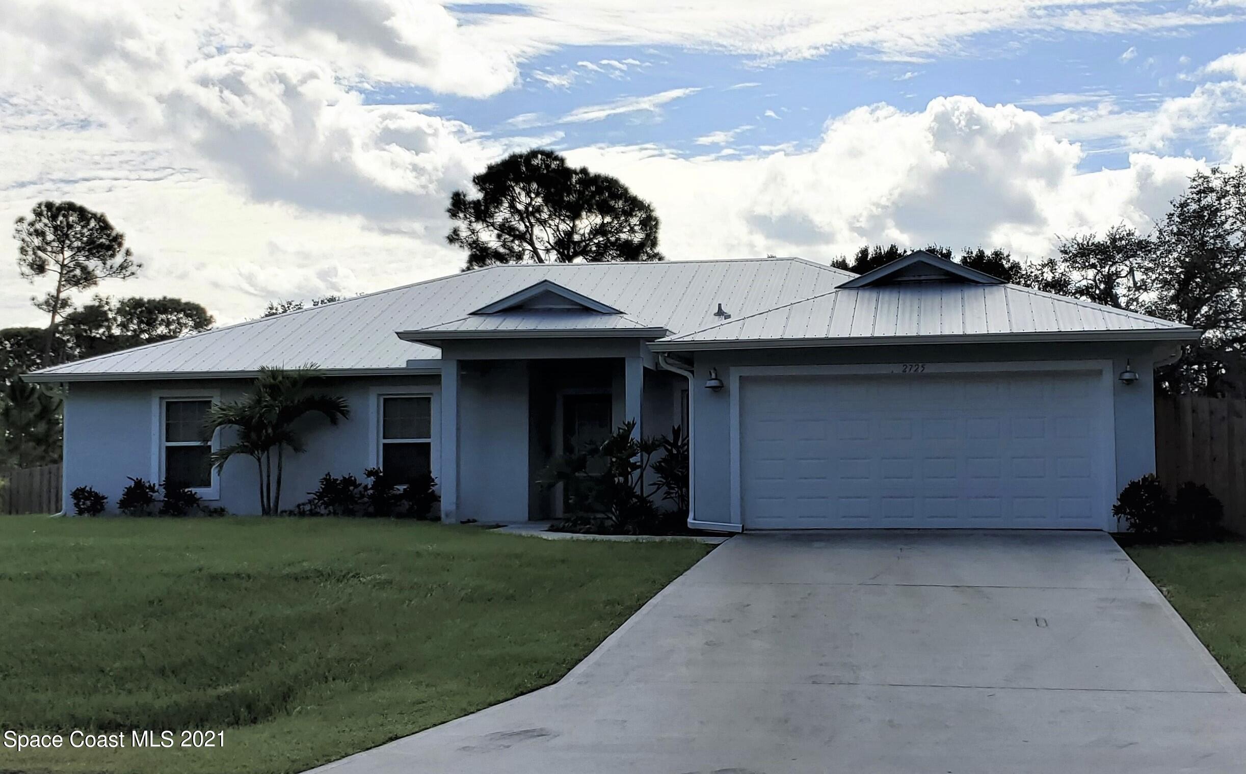 2725 Digby Road Southeast Palm Bay, FL 32909 - Photo 2 of 33 a house view with a garden space