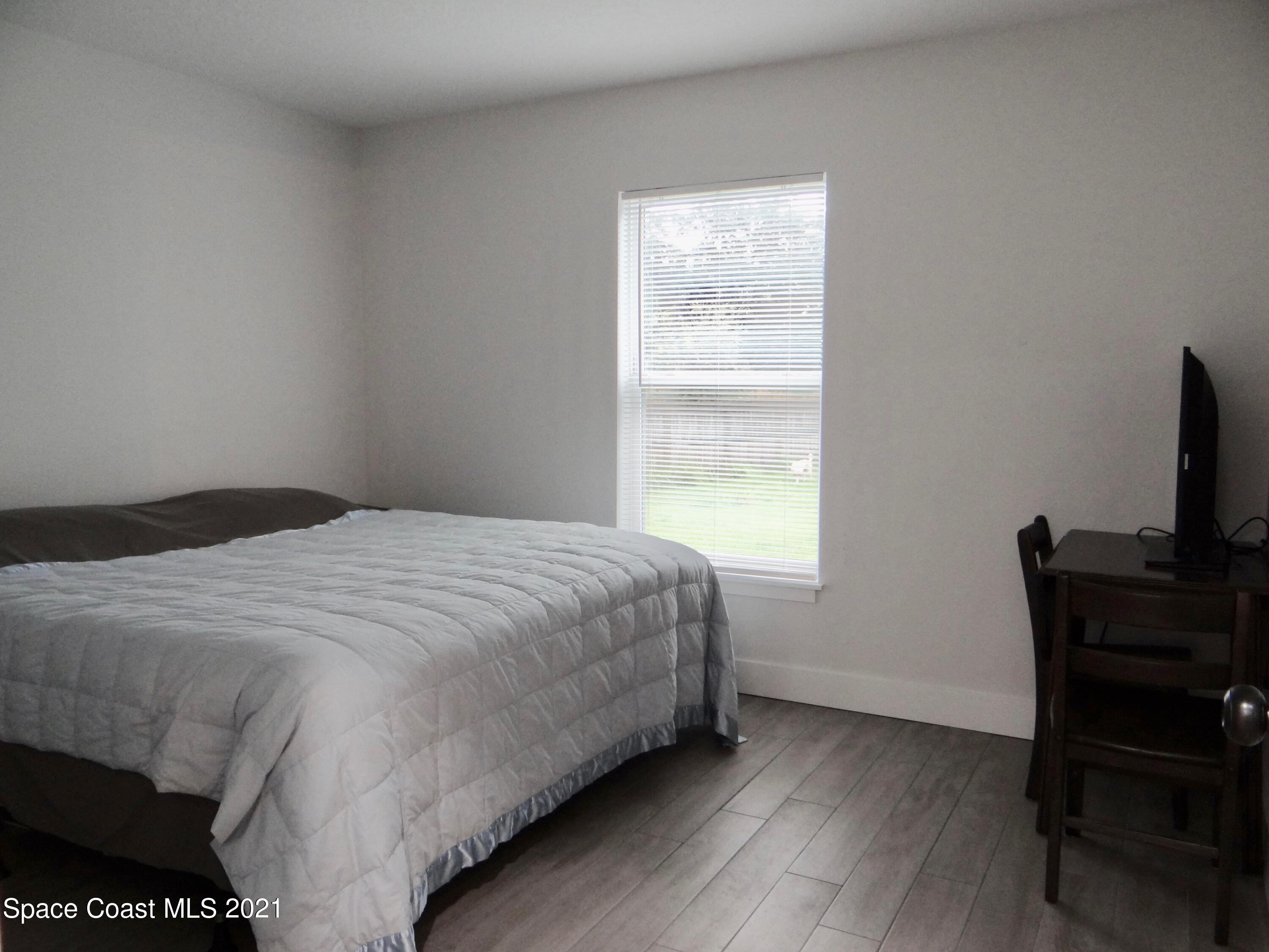 2725 Digby Road Southeast Palm Bay, FL 32909 - Photo 25 of 33 a bedroom with a bed and a window