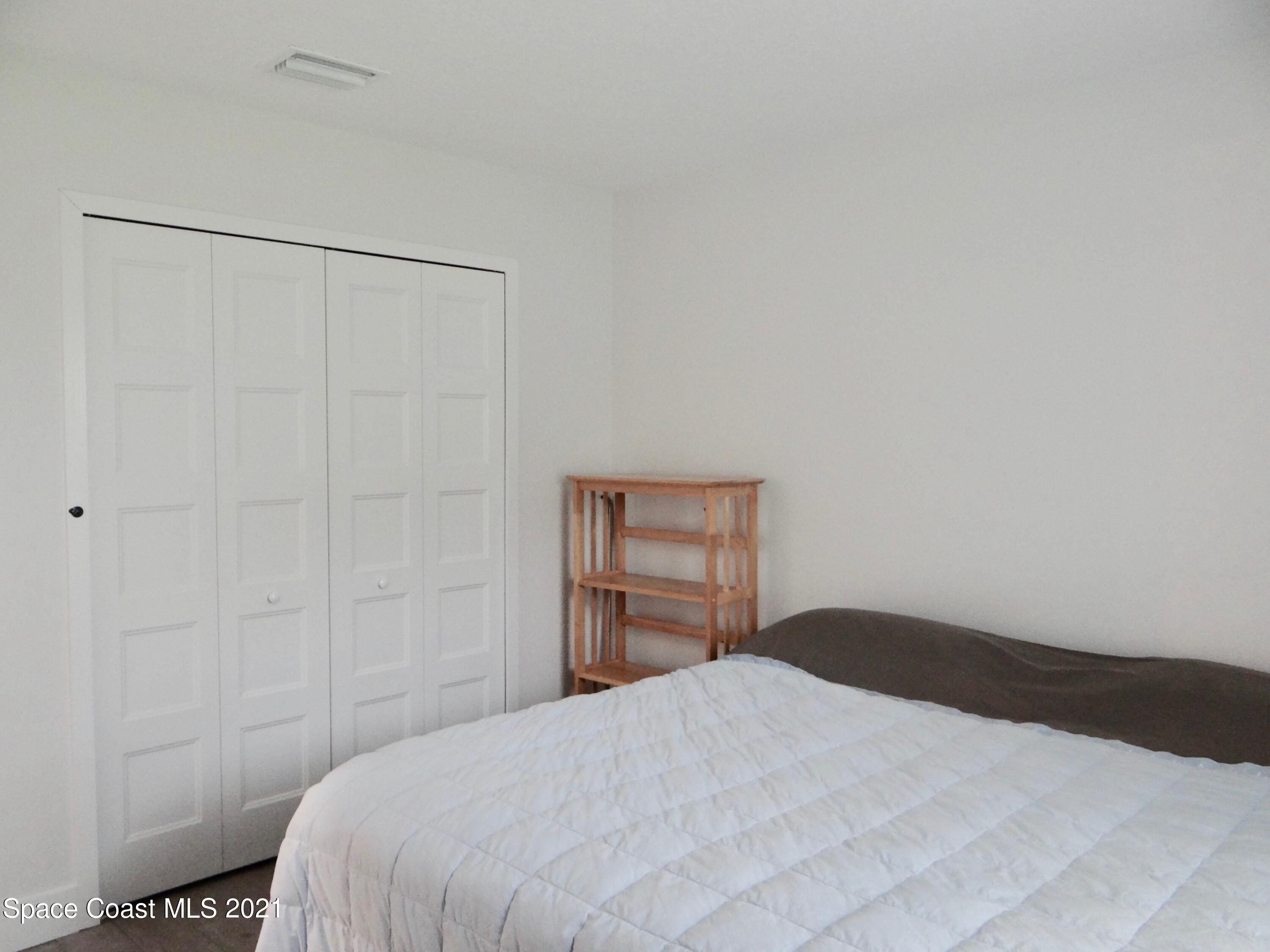 2725 Digby Road Southeast Palm Bay, FL 32909 - Photo 26 of 33 a bedroom with a bed and a closet