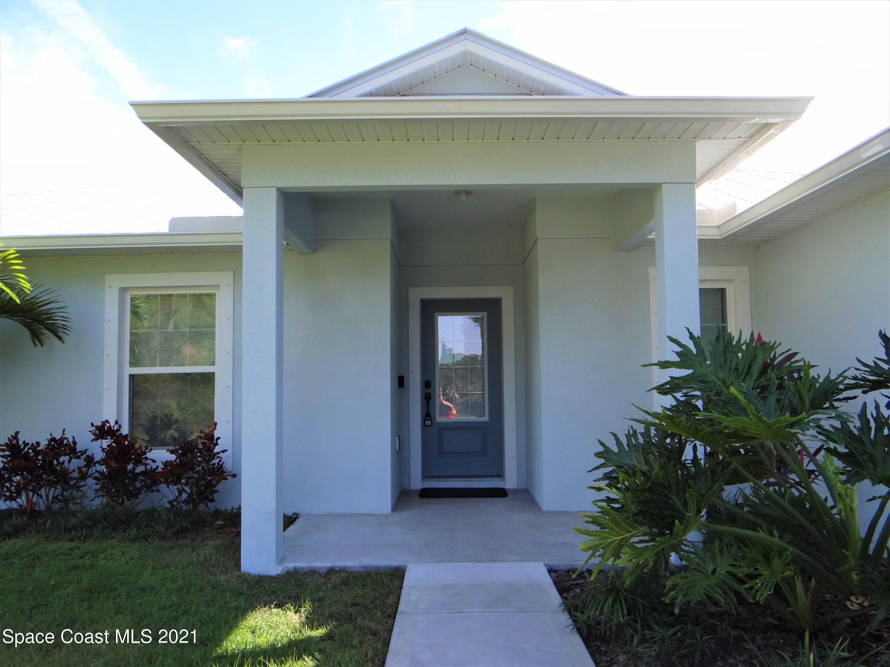 2725 Digby Road Southeast Palm Bay, FL 32909 - Photo 4 of 33 a front view of a house with garden