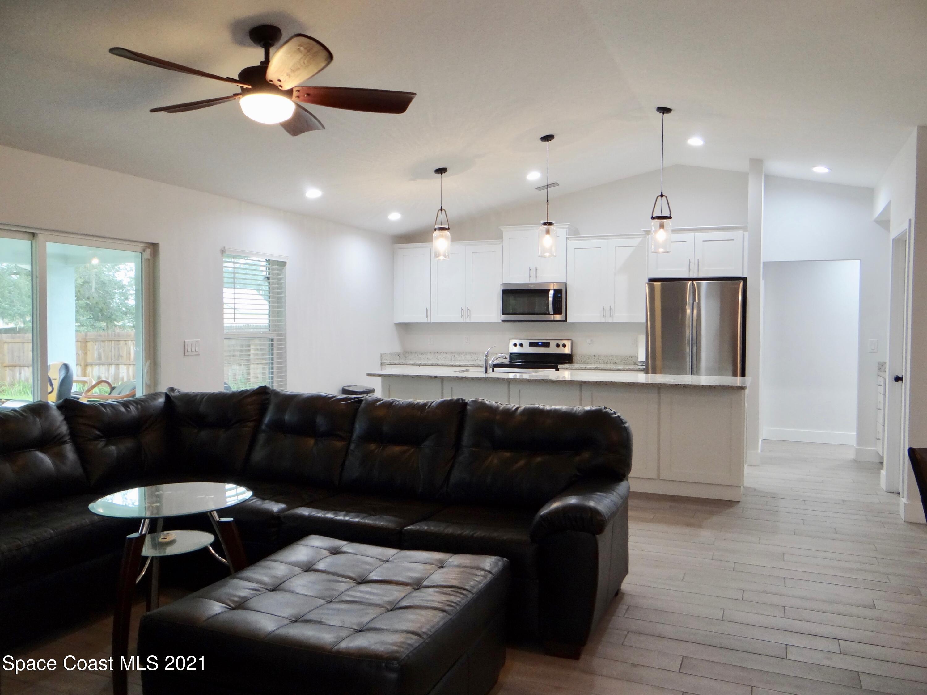 2725 Digby Road Southeast Palm Bay, FL 32909 - Photo 8 of 33 a living room with furniture and kitchen view