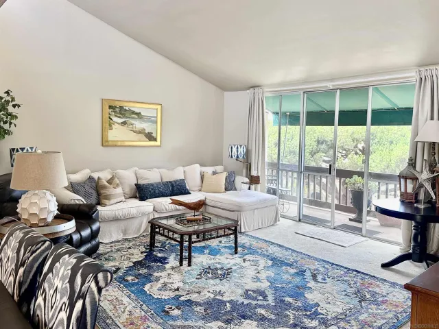 a living room with furniture and a floor to ceiling window