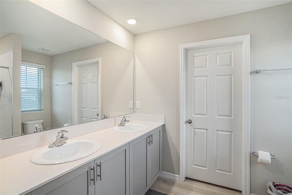 12940 Hawkstone Trail Boulevard Lithia, FL 33547 - Photo 13 of 33 a bathroom with 2 sink and a mirror