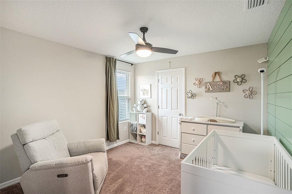 12940 Hawkstone Trail Boulevard Lithia, FL 33547 - Photo 14 of 33 a living room with furniture and a chandelier