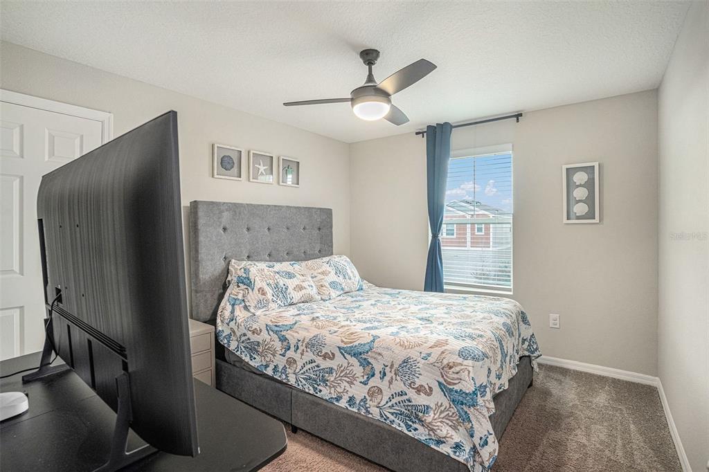 12940 Hawkstone Trail Boulevard Lithia, FL 33547 - Photo 15 of 33 a bedroom with a bed and a refrigerator
