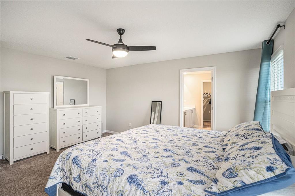 12940 Hawkstone Trail Boulevard Lithia, FL 33547 - Photo 19 of 33 a bedroom with a bed and a dresser