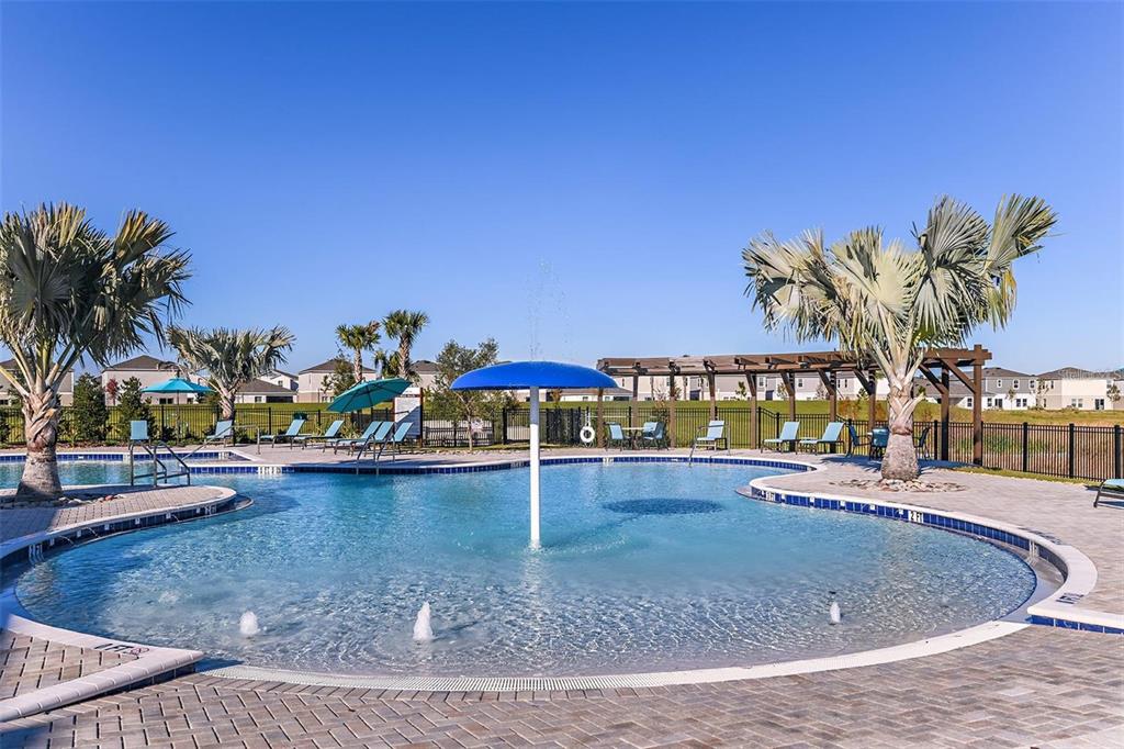 12940 Hawkstone Trail Boulevard Lithia, FL 33547 - Photo 26 of 33 a view of a swimming pool with a lawn chairs and potted plants