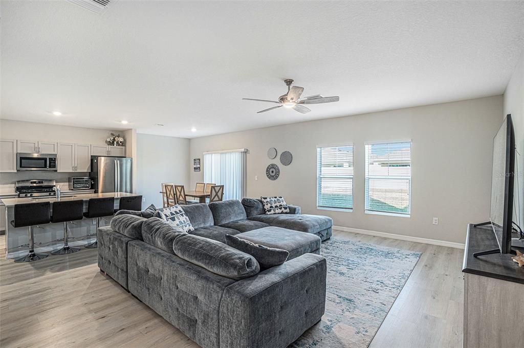 12940 Hawkstone Trail Boulevard Lithia, FL 33547 - Photo 6 of 33 a living room with furniture and a flat screen tv
