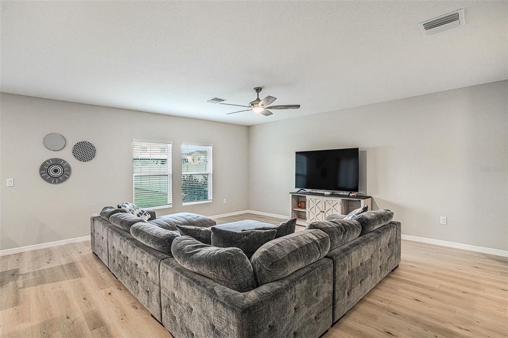 12940 Hawkstone Trail Boulevard Lithia, FL 33547 - Photo 7 of 33 a living room with furniture and a flat screen tv