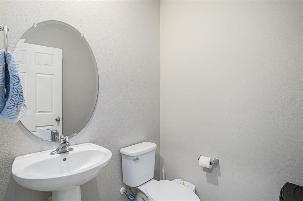 12940 Hawkstone Trail Boulevard Lithia, FL 33547 - Photo 9 of 33 a bathroom with a toilet a sink and mirror