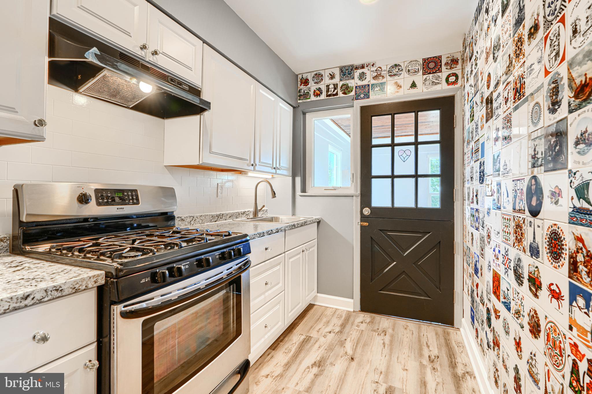 644 48th Street Baltimore, MD 21224 - Photo 11 of 37 a kitchen with stainless steel appliances a stove a sink and a refrigerator