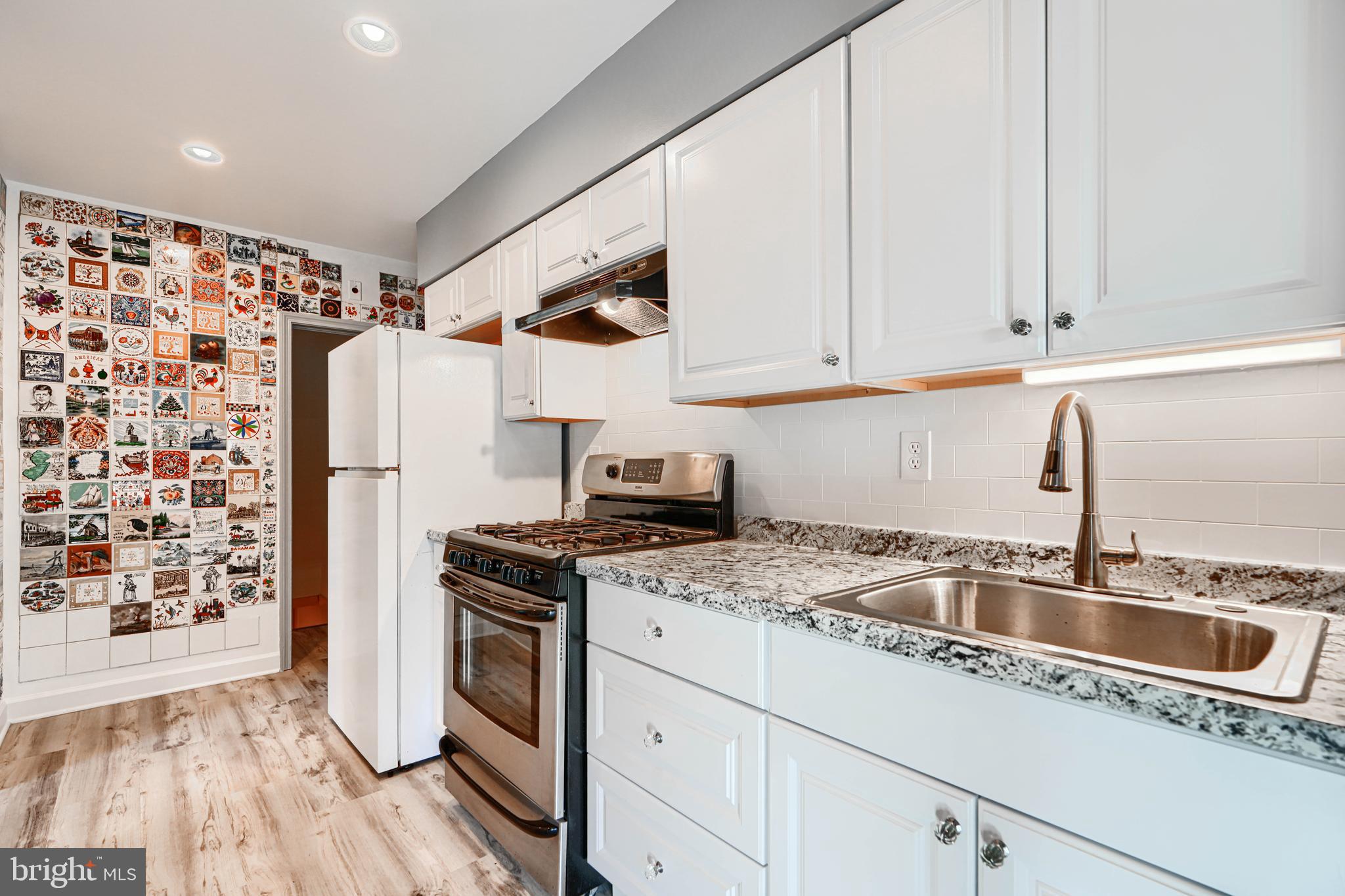 644 48th Street Baltimore, MD 21224 - Photo 12 of 37 a kitchen with stainless steel appliances granite countertop a sink stove and refrigerator
