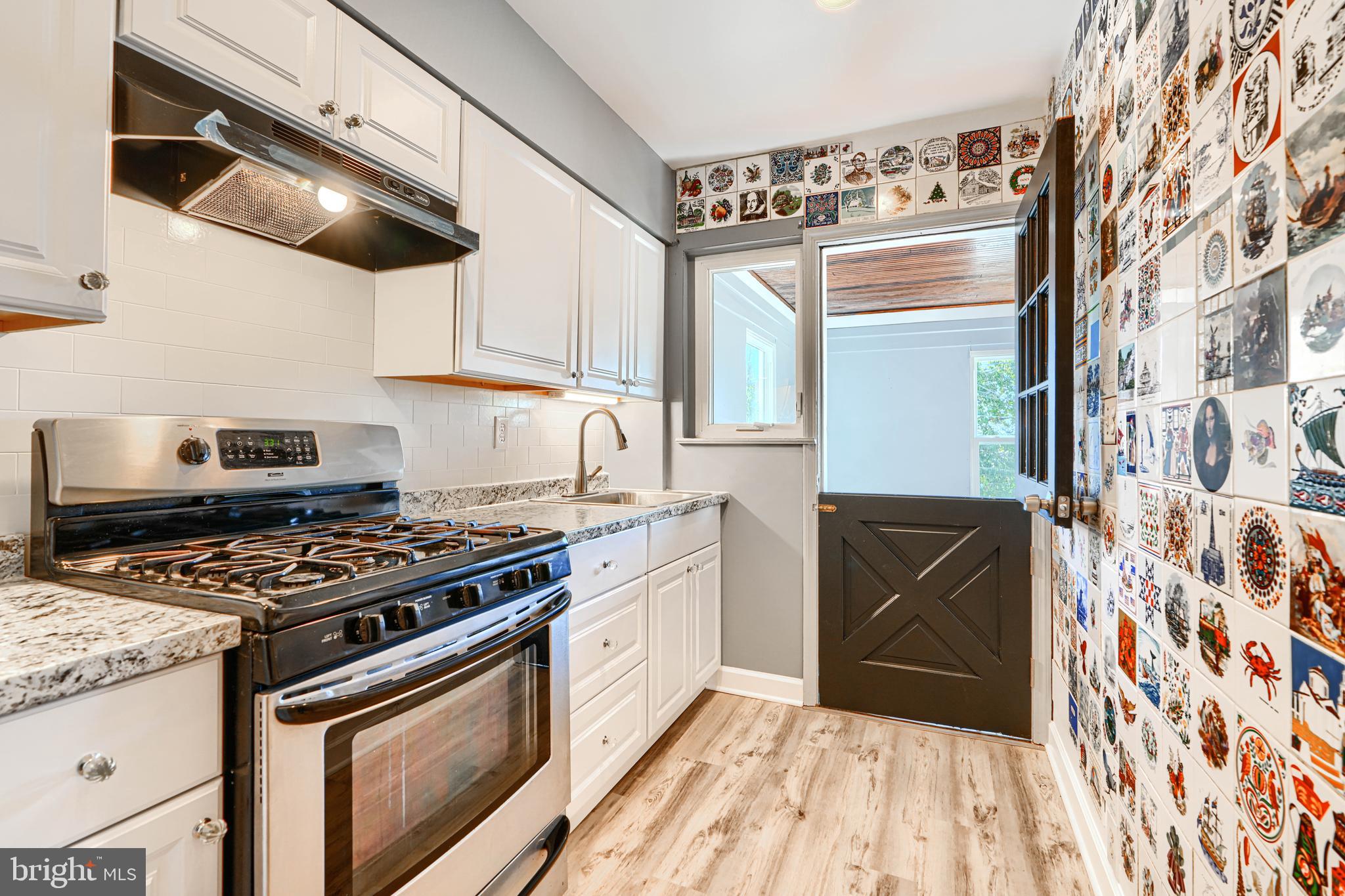 644 48th Street Baltimore, MD 21224 - Photo 13 of 37 a kitchen with stainless steel appliances granite countertop a stove and a sink