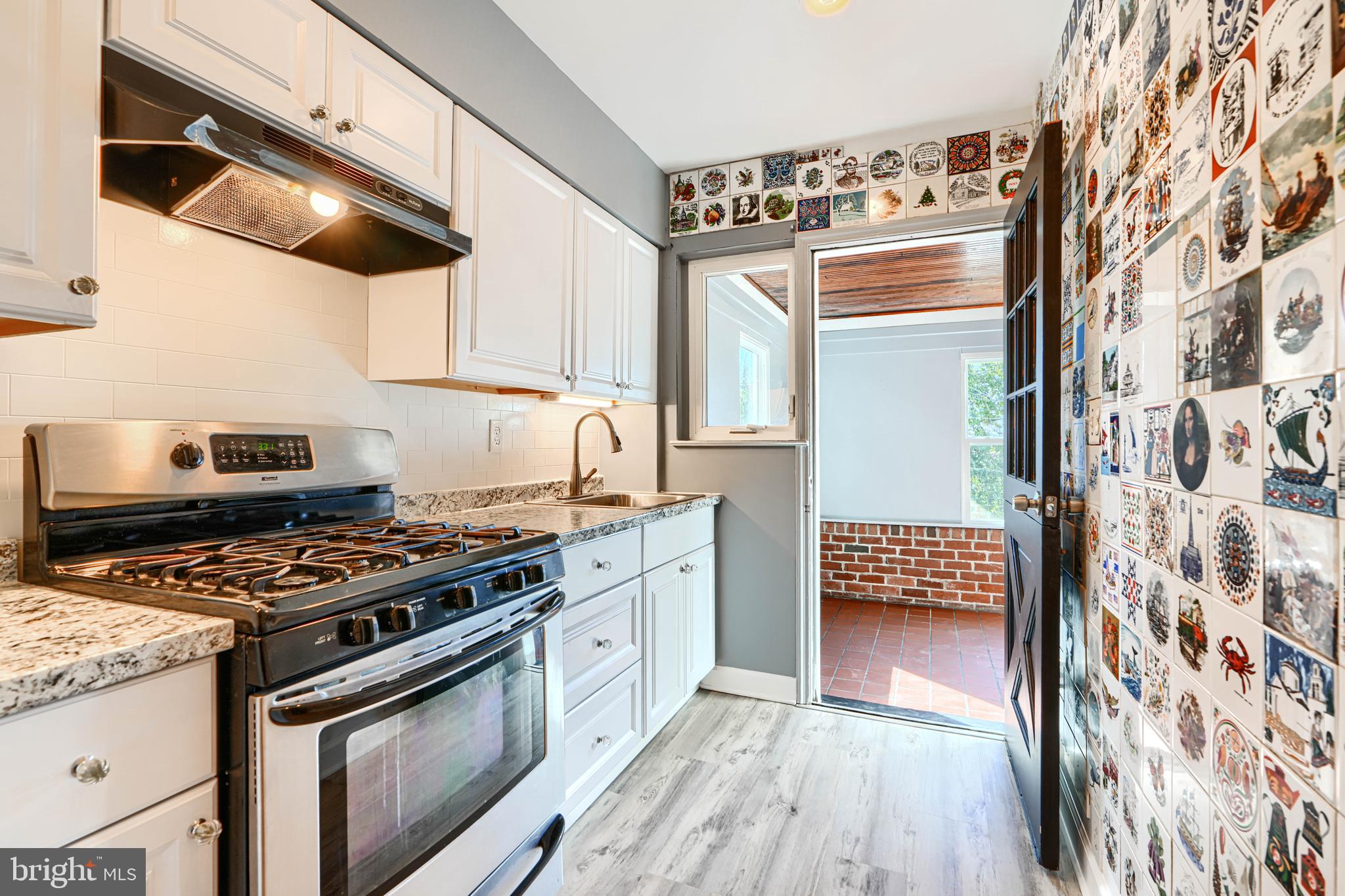 644 48th Street Baltimore, MD 21224 - Photo 14 of 37 a kitchen with stainless steel appliances granite countertop a stove and a sink