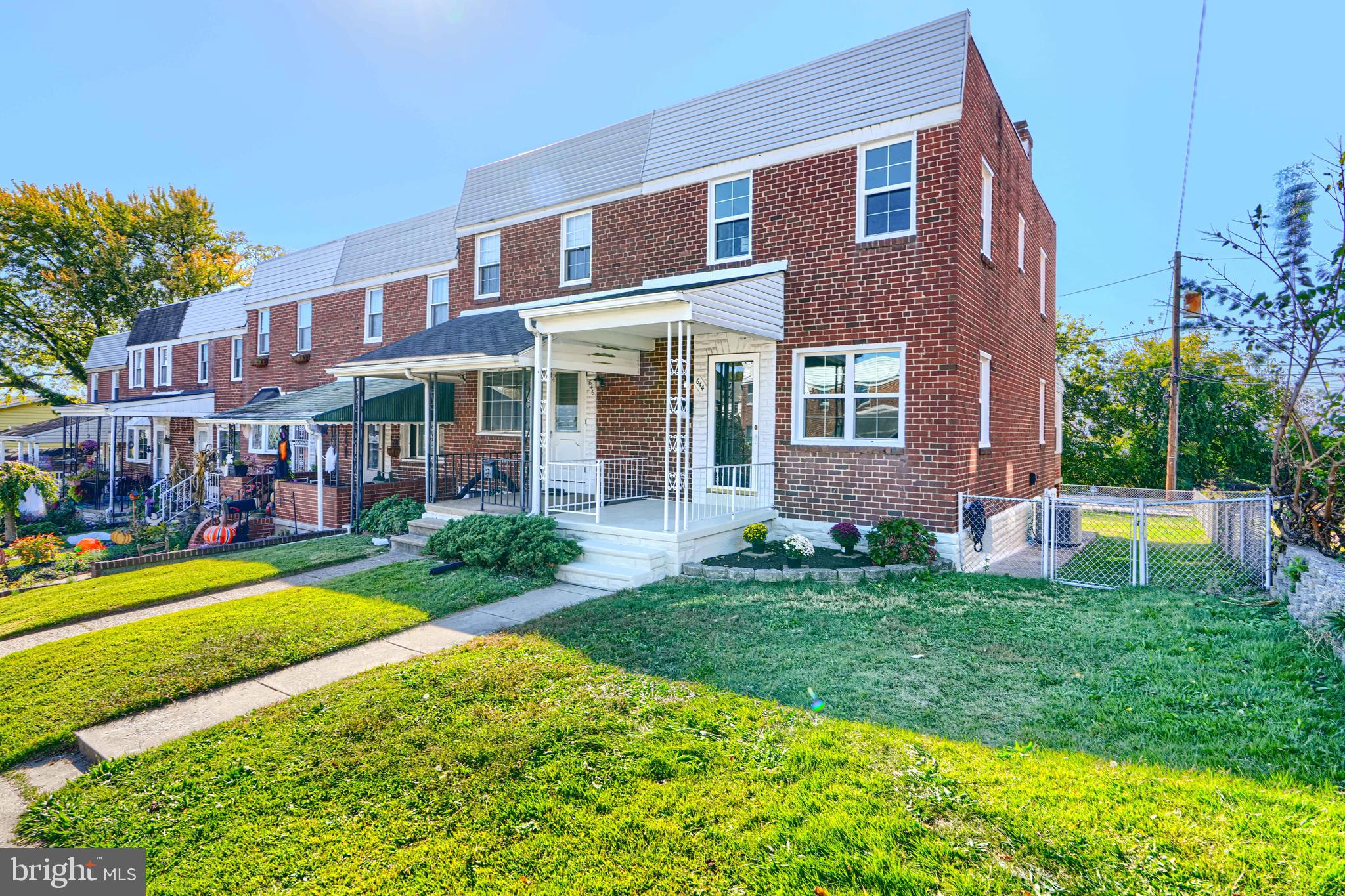 644 48th Street Baltimore, MD 21224 - Photo 2 of 37 a view of a brick building next to a big yard and large trees