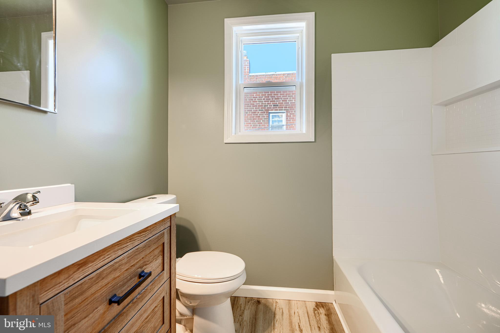 644 48th Street Baltimore, MD 21224 - Photo 26 of 37 a bathroom with a sink a toilet and a window