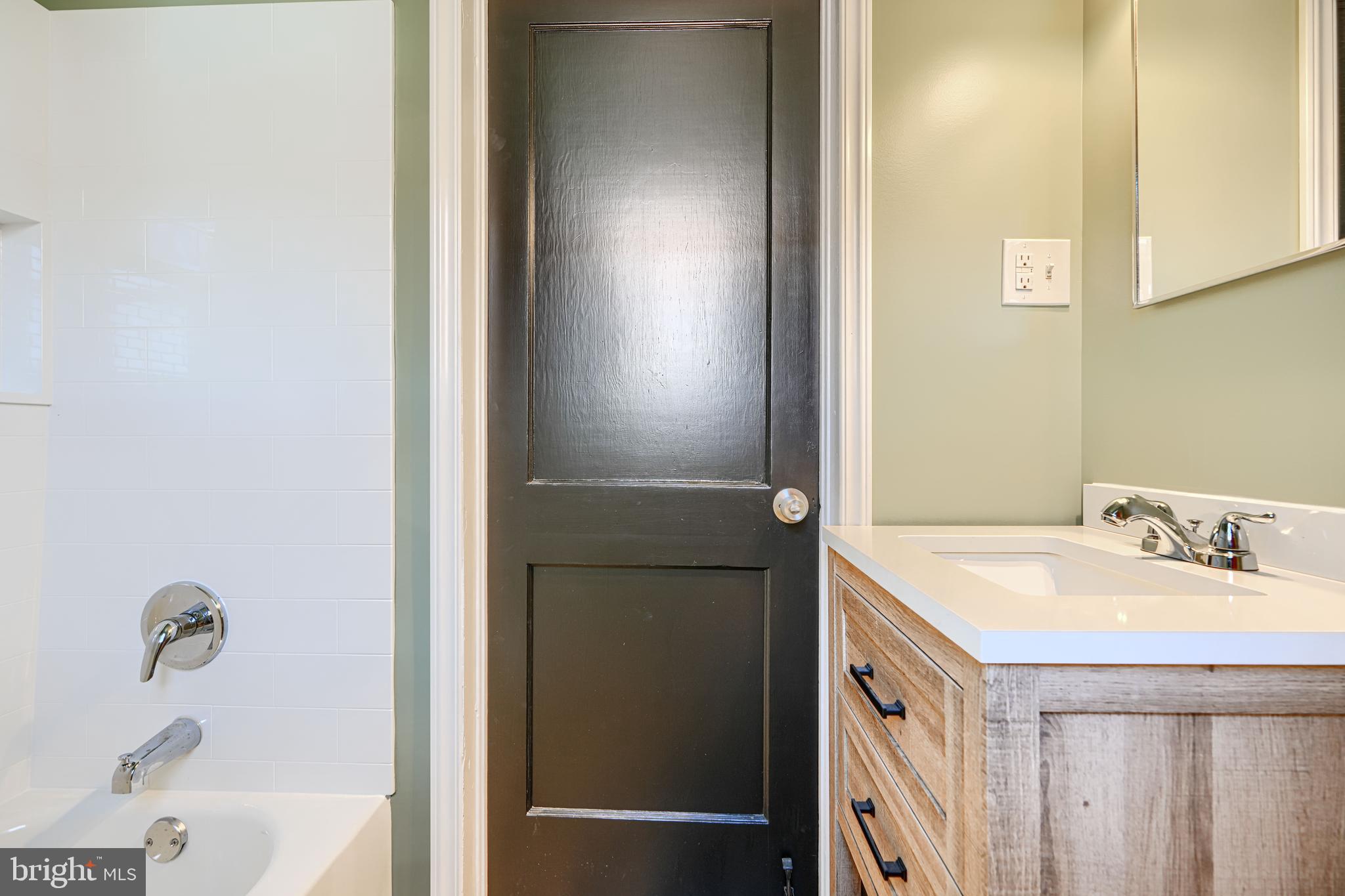 644 48th Street Baltimore, MD 21224 - Photo 27 of 37 a bathroom with a sink and a mirror