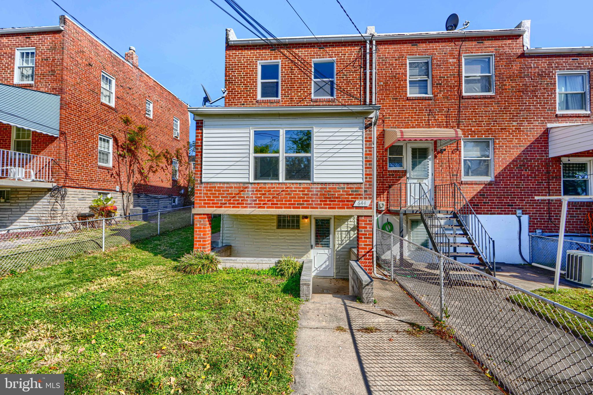 644 48th Street Baltimore, MD 21224 - Photo 35 of 37 a front view of a house with a garden