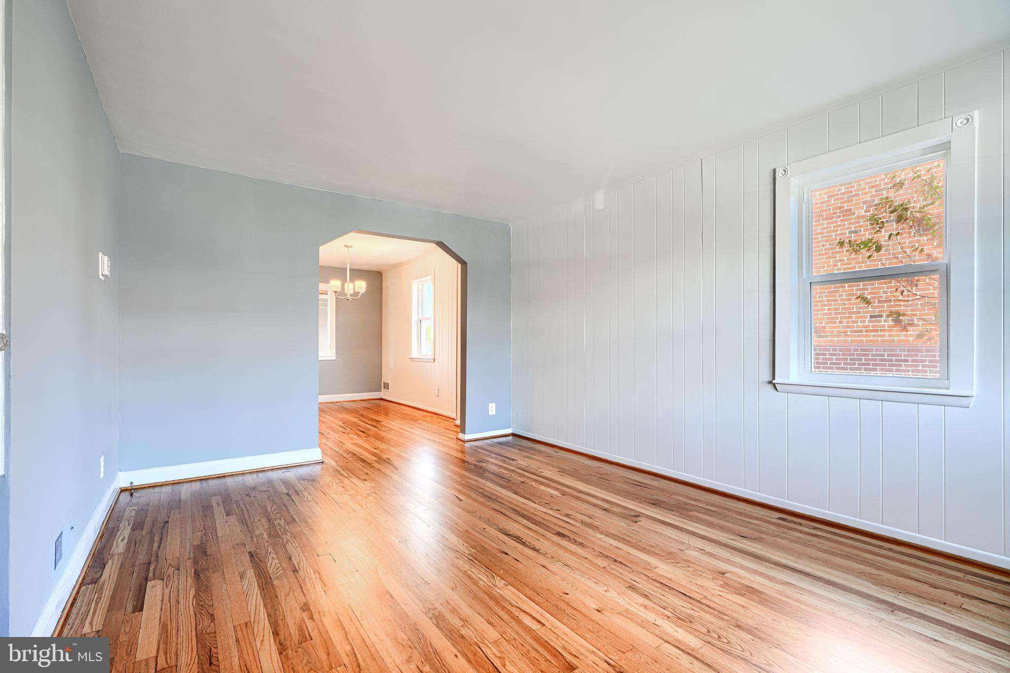 644 48th Street Baltimore, MD 21224 - Photo 5 of 37 a view of empty room with wooden floor and fan