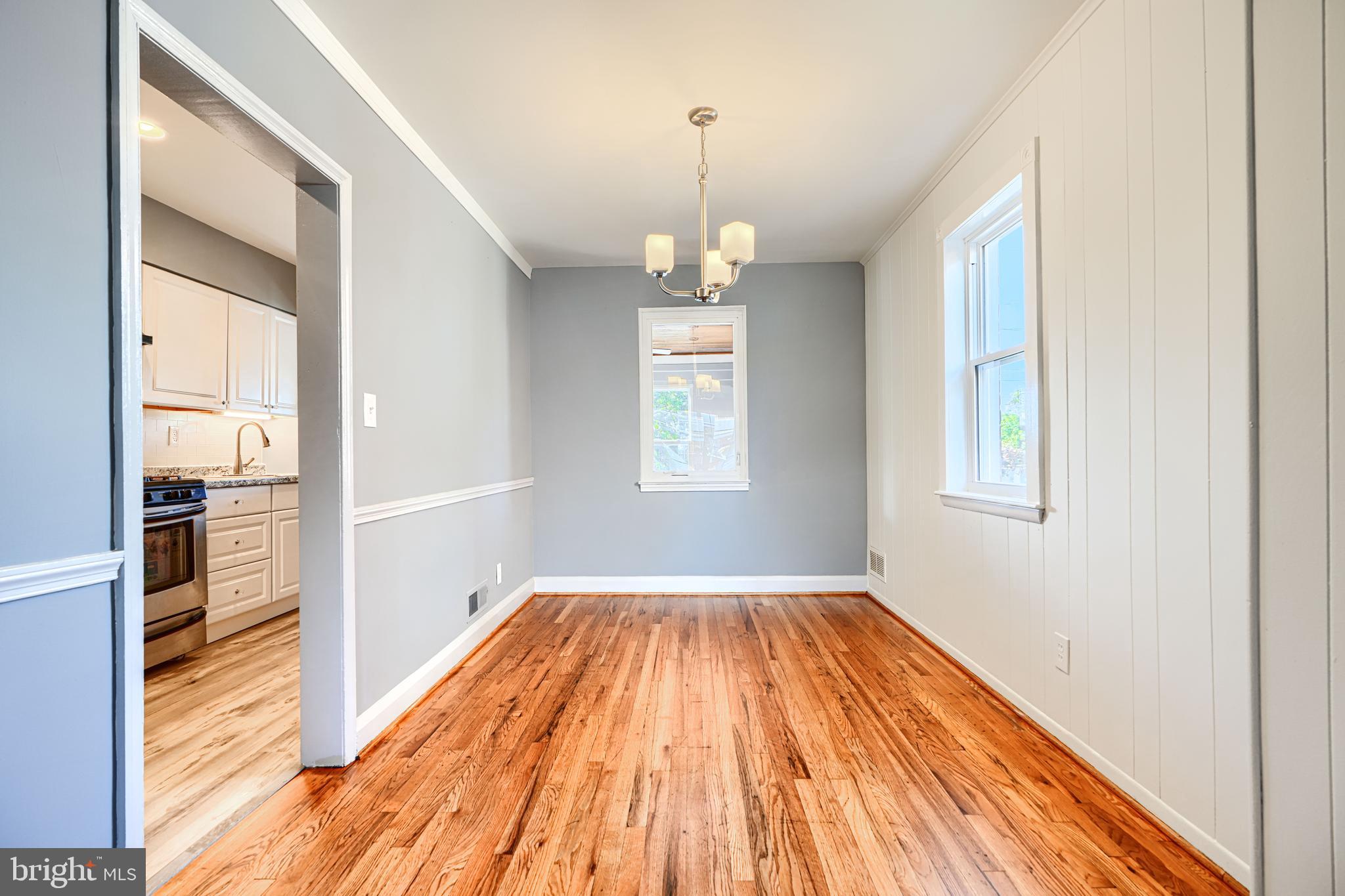 644 48th Street Baltimore, MD 21224 - Photo 8 of 37 a view of a room with wooden floor kitchen and windows