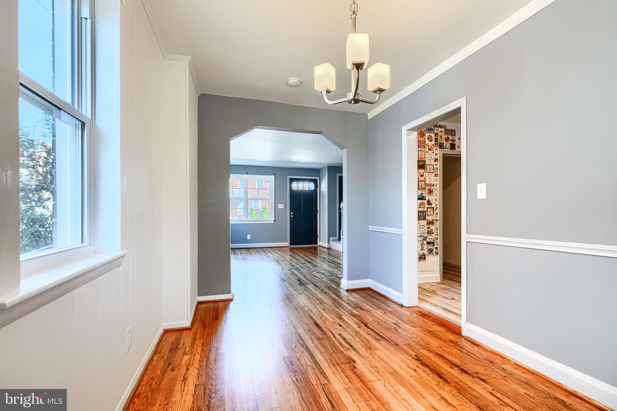 644 48th Street Baltimore, MD 21224 - Photo 10 of 37 a view of a hallway with wooden floor and chandelier