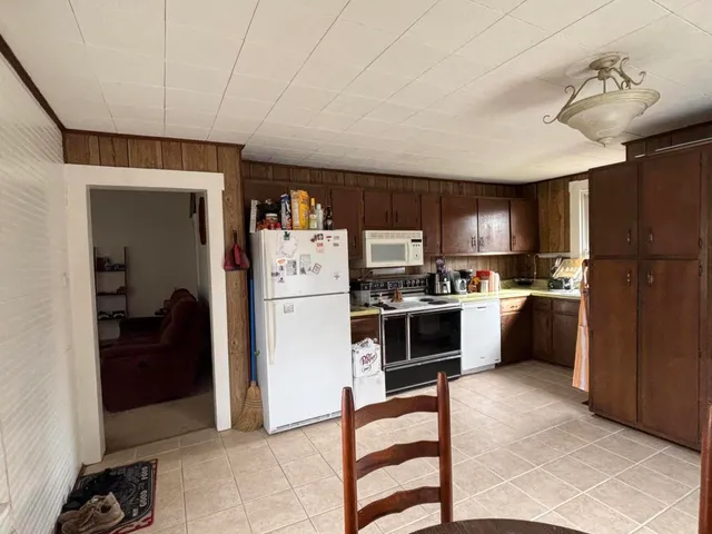 a kitchen with a refrigerator a stove and a cabinets