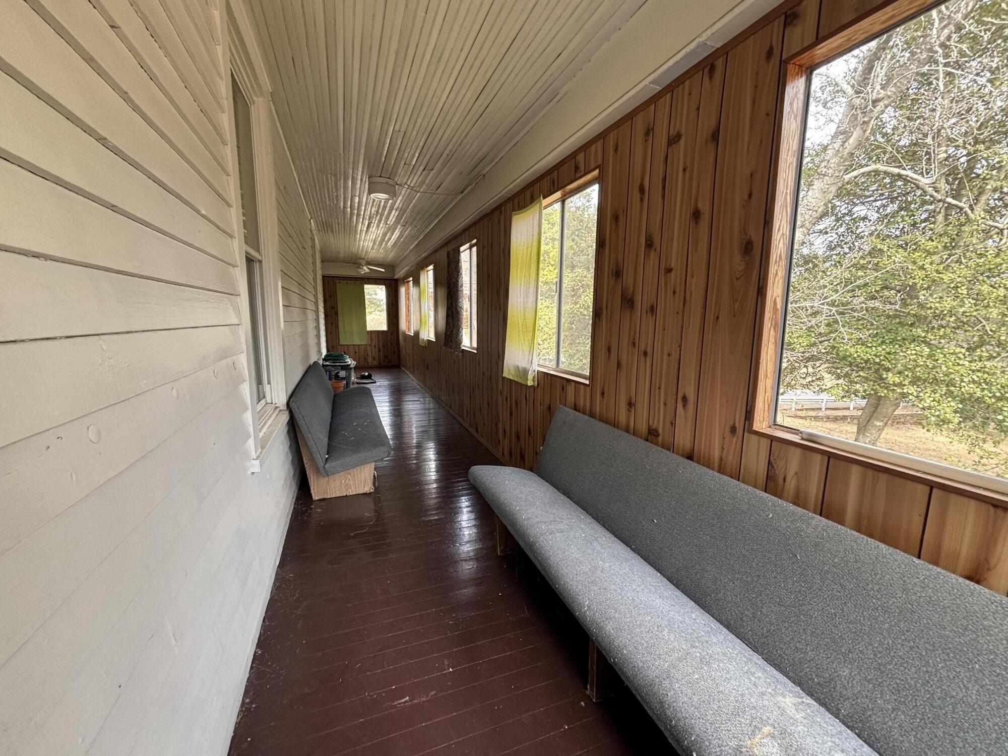 165 West College Street Rocky Mount, VA 24151 - Photo 15 of 24 a hallway with couches and large windows with wooden floor