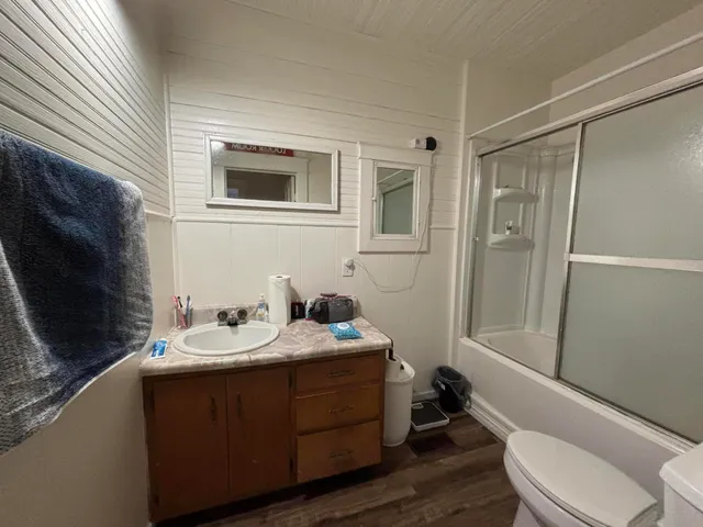 a living room with a fireplace and a wooden floor
