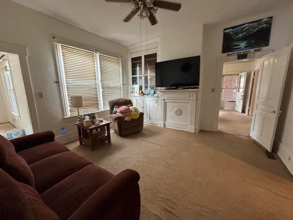 a view of a room with chairs and windows