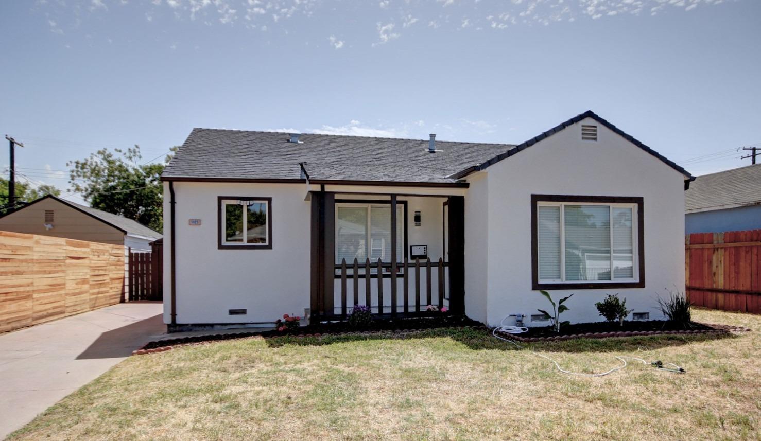 3825 San Carlos Way Sacramento, CA 95820 - Photo 1 of 1 a front view of a house with a garden