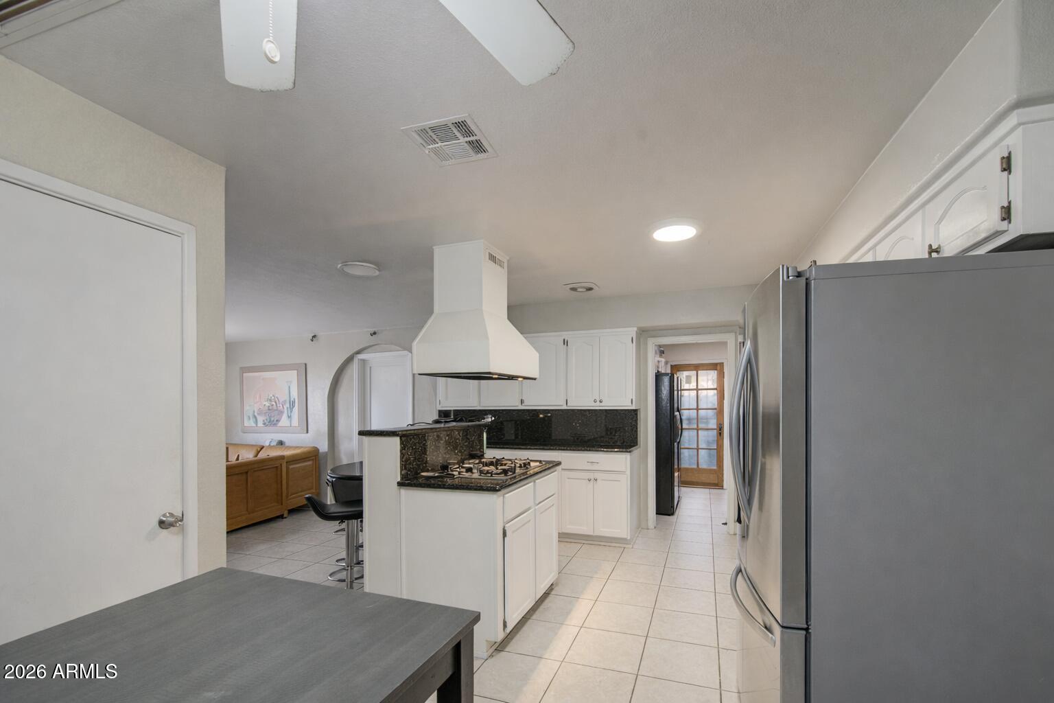 3107 West Montebello Avenue Phoenix, AZ 85017 - Photo 10 of 30 a kitchen with a sink stove and refrigerator