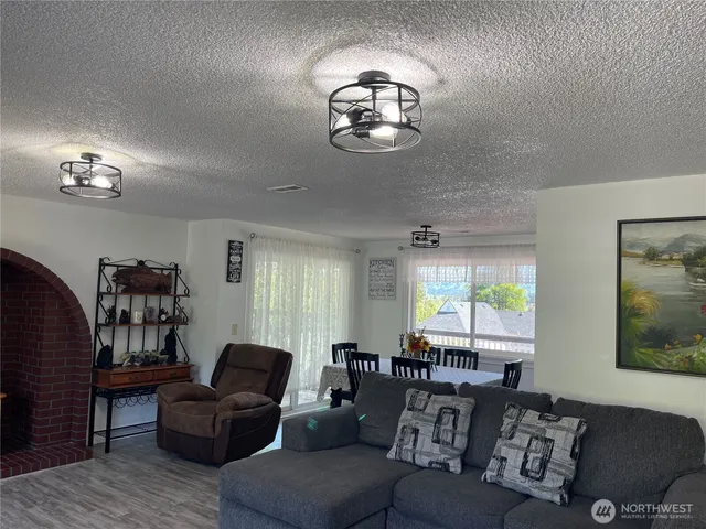 a living room with furniture a chandelier and a window