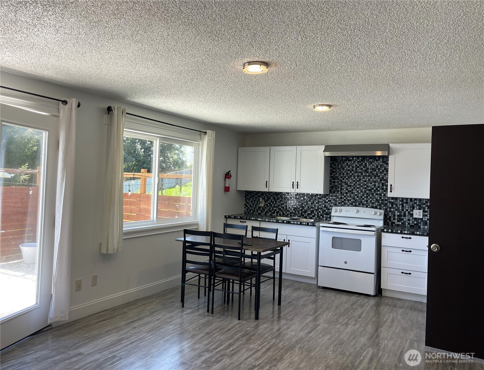 1017 Ballentine Street Raymond, WA 98577 - Photo 12 of 33 a kitchen with a table and chairs in it