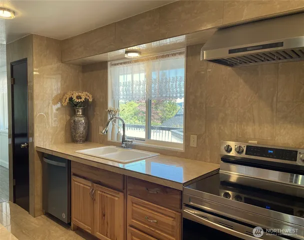 a hallway with a sink and a large mirror