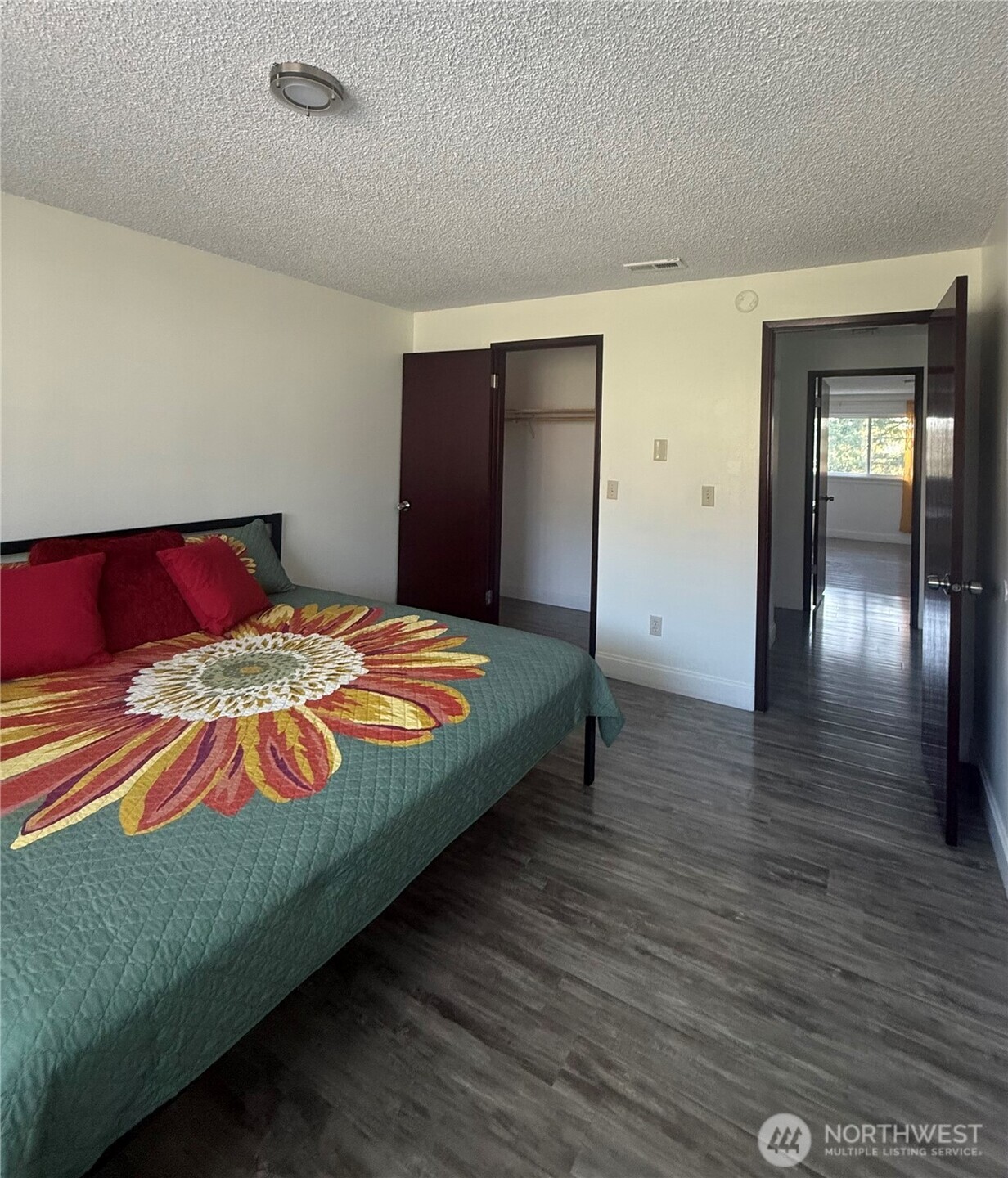 1017 Ballentine Street Raymond, WA 98577 - Photo 14 of 33 a bedroom with a bed and wooden floor