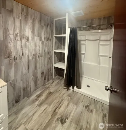 a bathroom with a shower and a glass door