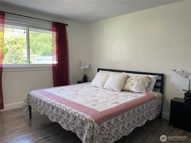 a bedroom with a bed and window