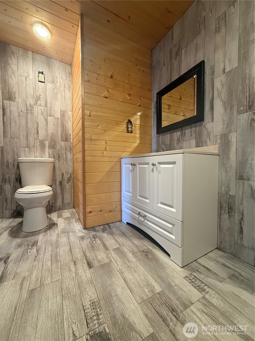 1017 Ballentine Street Raymond, WA 98577 - Photo 22 of 33 a bathroom with a sink a toilet and mirror